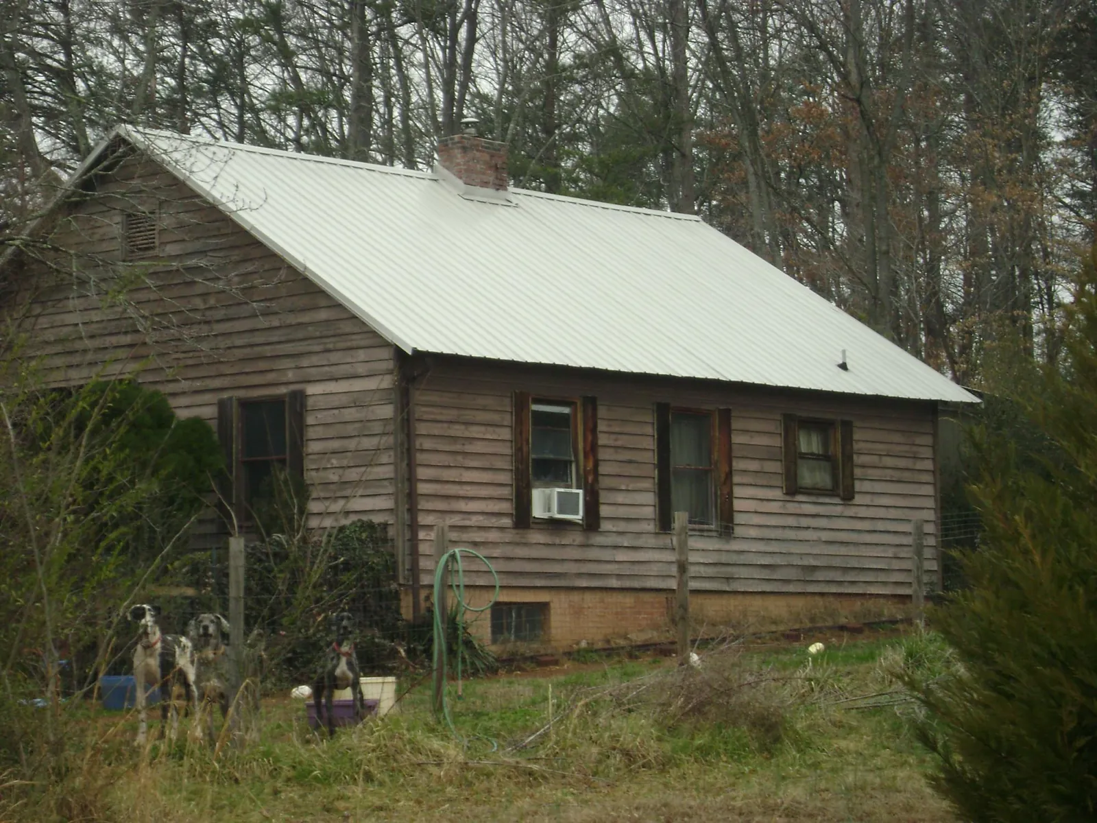 White metal roof on an old wood sided farmhouse, from a Metal Roof Installation job in East China